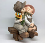 Figuren Kinder sitzend auf Bank 
Junge und Mädchen 
aus Polyresin