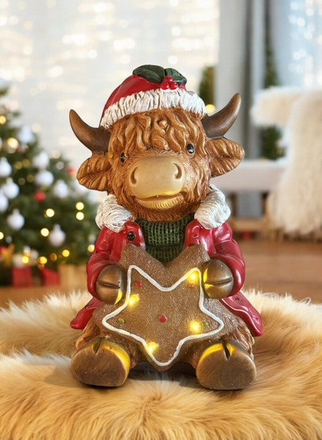 LED Deko Hochlandrind mit 4 LED sitzend mit Stern in der Hand