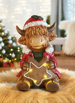 LED Deko Hochlandrind mit 4 LED sitzend mit Stern in der Hand