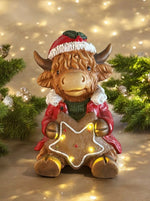 LED Deko Hochlandrind mit 4 LED sitzend mit Stern in der Hand