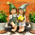 Dekofiguren Kinder sitzend auf Bank mit Zitronen