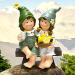 Dekofiguren Kinder sitzend auf Bank mit Zitronen