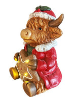 LED Deko Hochlandrind mit 4 LED sitzend mit Stern in der Hand