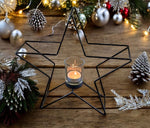 Kerzenhalter Stern 
in Schwarz aus Metall 
H: 28cm B: 29cm T: 8cm