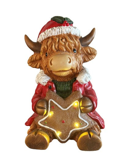 LED Deko Hochlandrind mit 4 LED sitzend mit Stern in der Hand